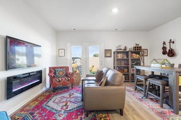 a living room with furniture and a wooden floor