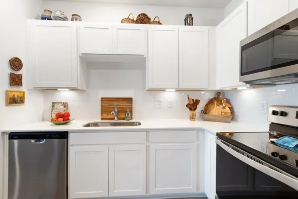 a kitchen with stainless steel appliances white cabinets and a stove