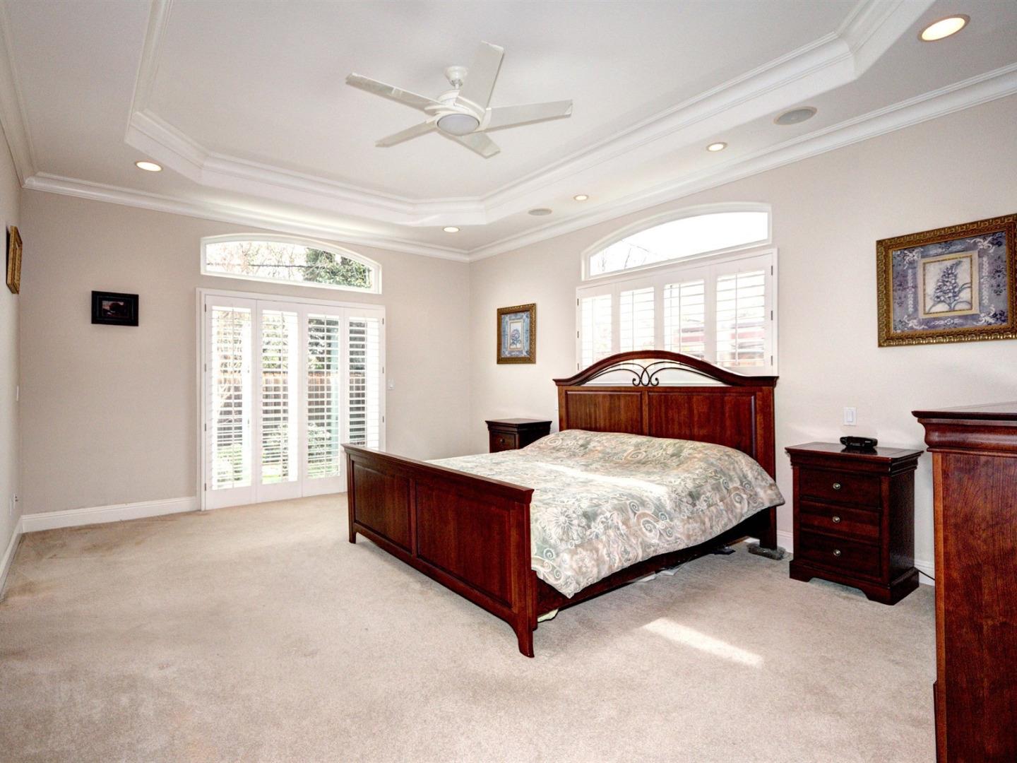10340 Moretti Drive Cupertino, CA 95014 - Photo 11 of 18 a bedroom with a bed lamp and a large window
