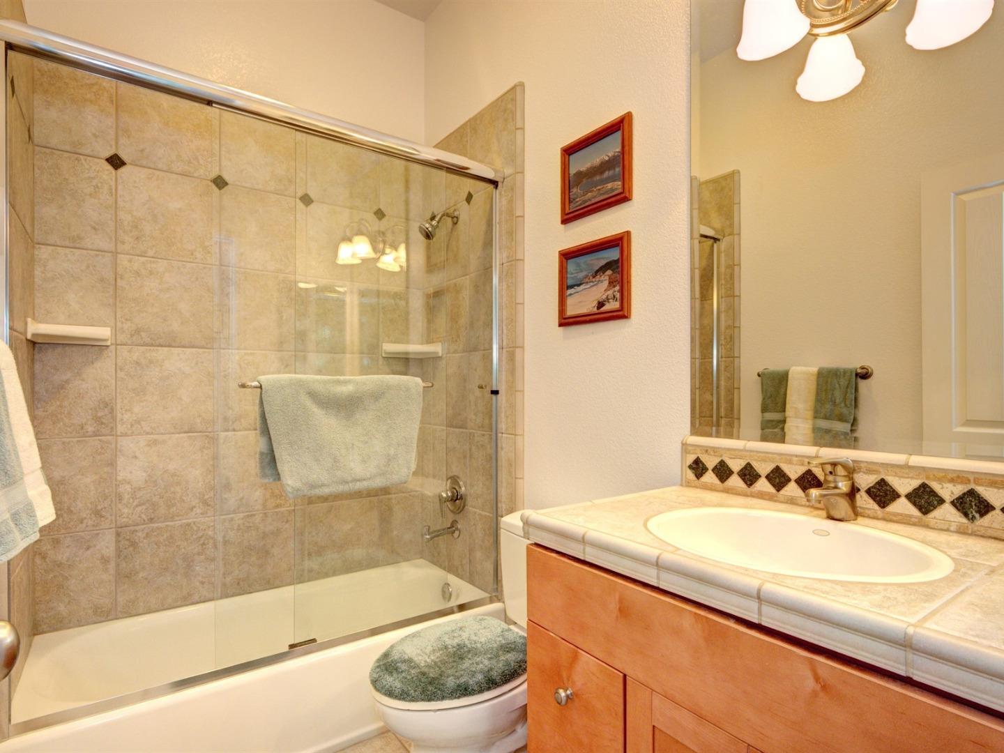 10340 Moretti Drive Cupertino, CA 95014 - Photo 15 of 18 a bathroom with a granite countertop sink a toilet and shower