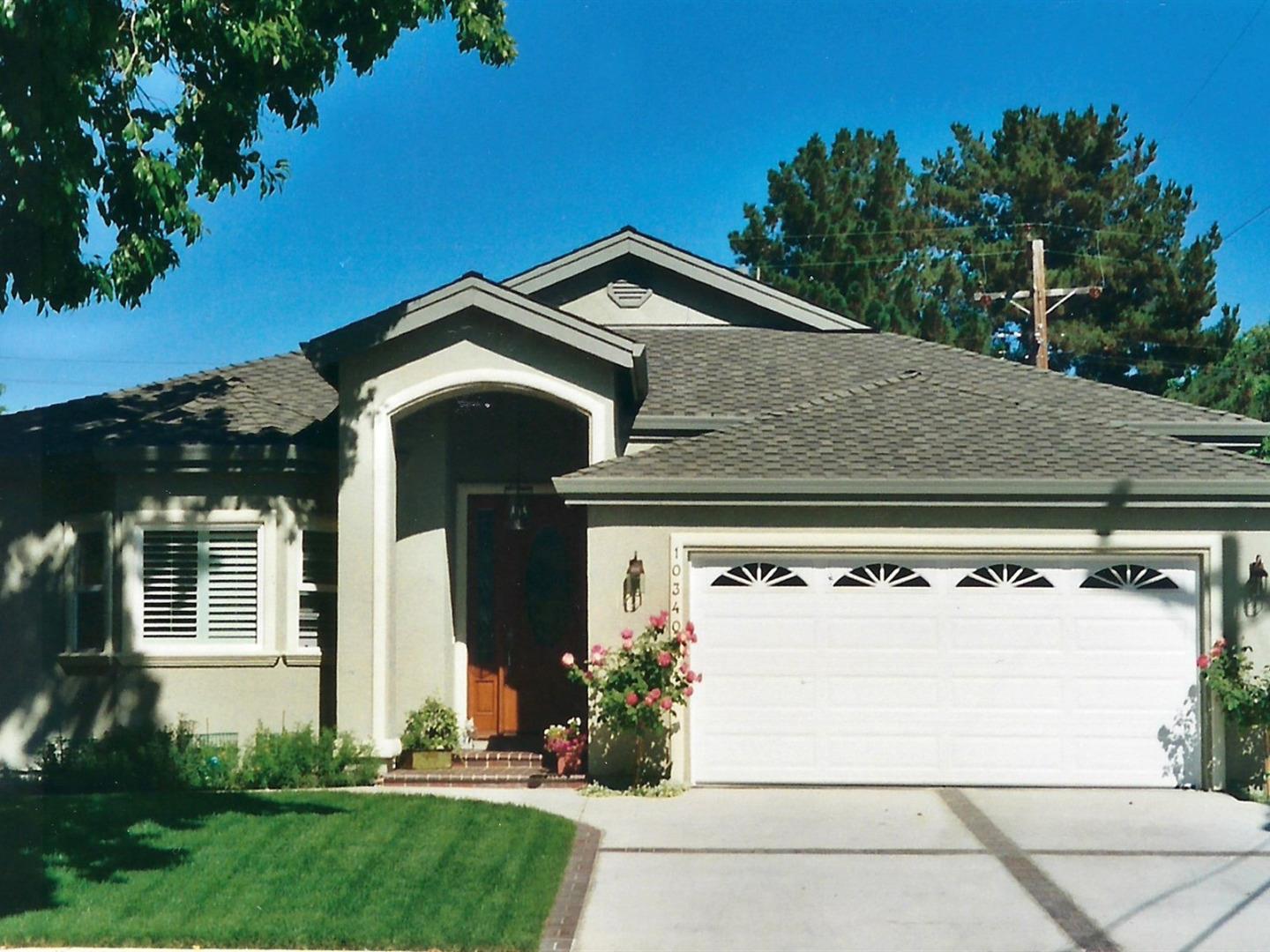 10340 Moretti Drive Cupertino, CA 95014 - Photo 2 of 18 a front view of a house with garden