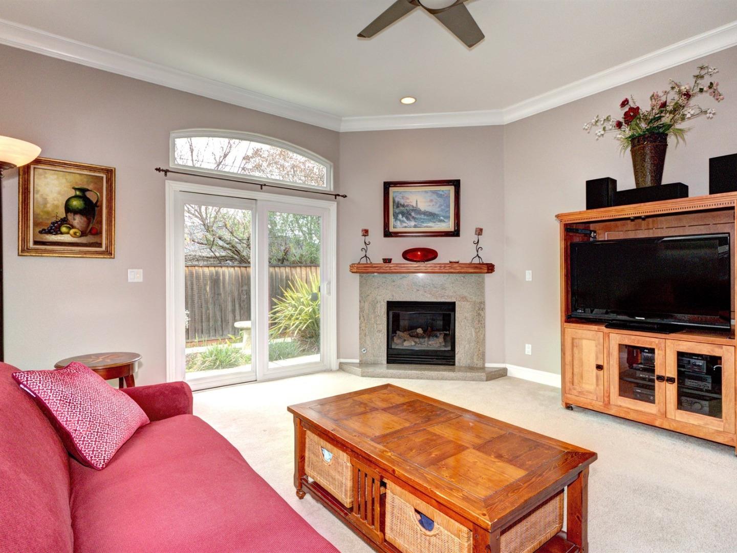 10340 Moretti Drive Cupertino, CA 95014 - Photo 4 of 18 a living room with furniture a flat screen tv and a fireplace