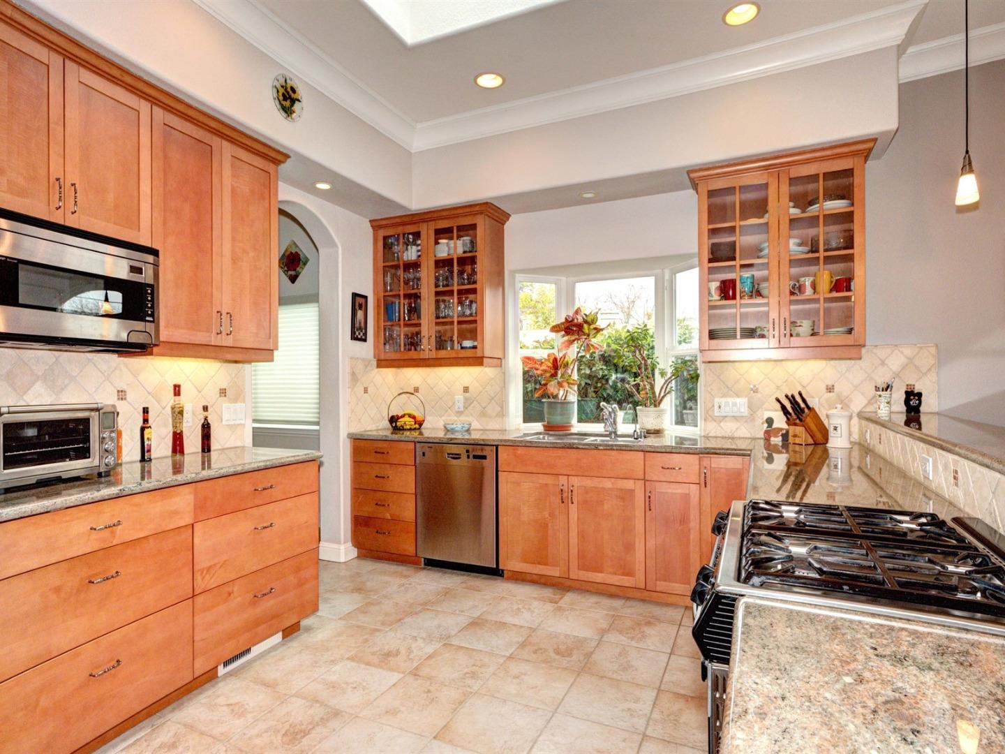 10340 Moretti Drive Cupertino, CA 95014 - Photo 8 of 18 a kitchen with stainless steel appliances granite countertop a stove and a sink