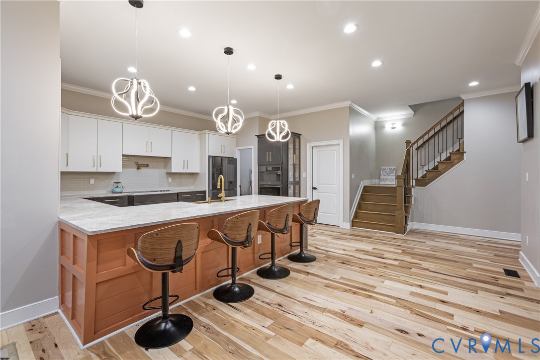 12554 Kain Road Glen Allen, VA 23059 - Photo 20 of 74 Kitchen featuring a large island with paneling, wh