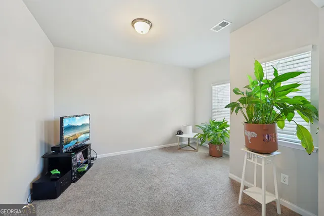 a spacious bedroom with a bed and a chandelier