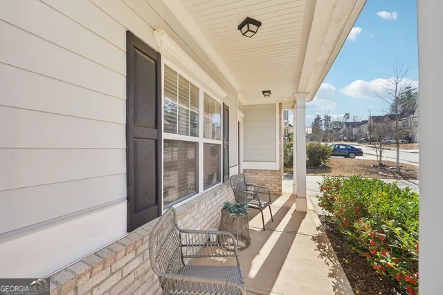 a balcony with couch and wooden floor