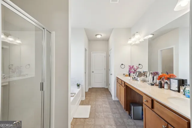 a kitchen with stainless steel appliances granite countertop a refrigerator oven stove a sink a dining table and chairs with wooden floor