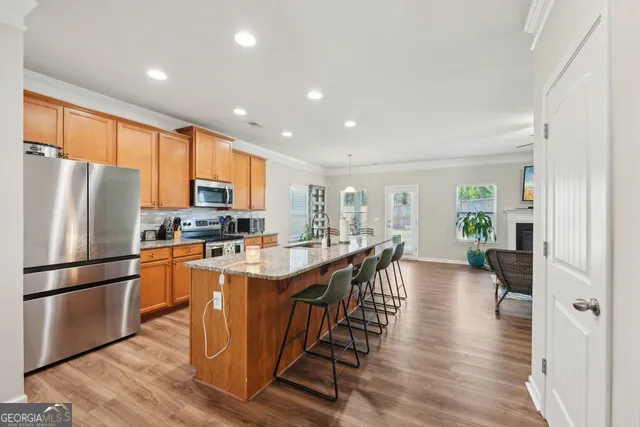 a bedroom with a bed a chair and a large window