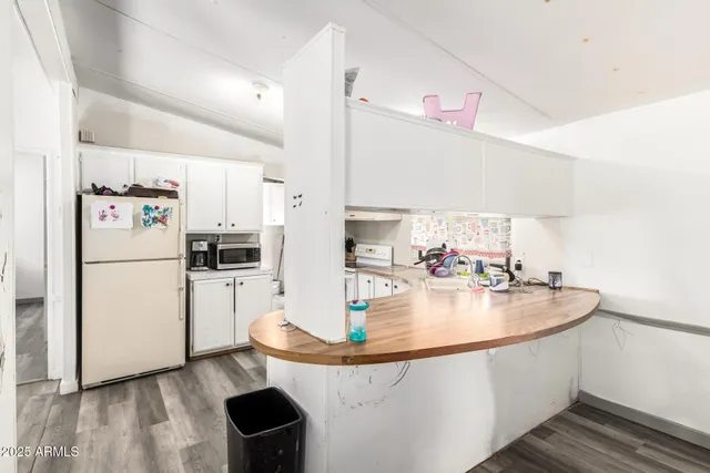 a kitchen with kitchen island a sink appliances and cabinets