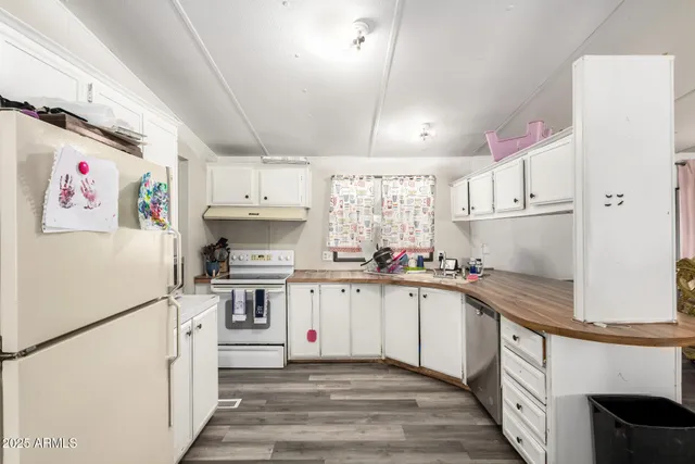 a kitchen with white cabinets and white appliances