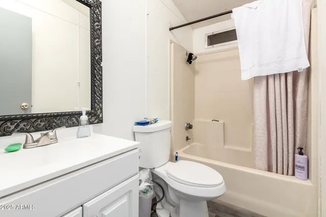 a bedroom with a bed and a ceiling fan