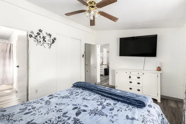 a bedroom with a bed and wooden floor