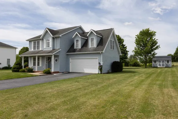 a front view of a house with a garden and yard