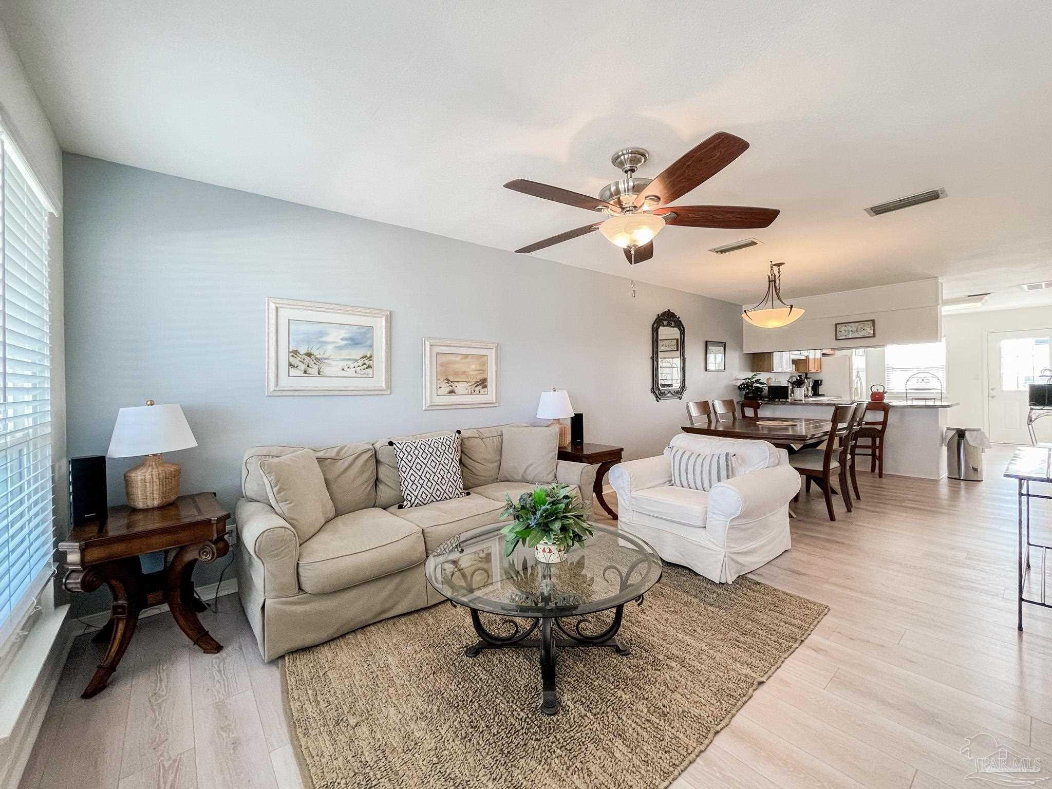 13948 River Road, Unit 3A Pensacola, FL 32507 - Photo 13 of 47 a living room with furniture and a chandelier