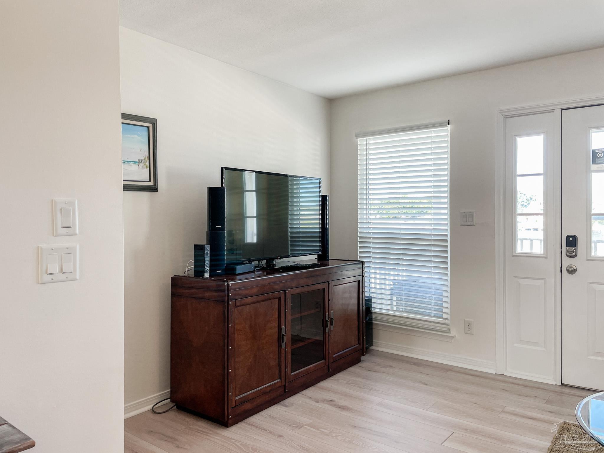 13948 River Road, Unit 3A Pensacola, FL 32507 - Photo 15 of 47 a living room with furniture and flat screen tv
