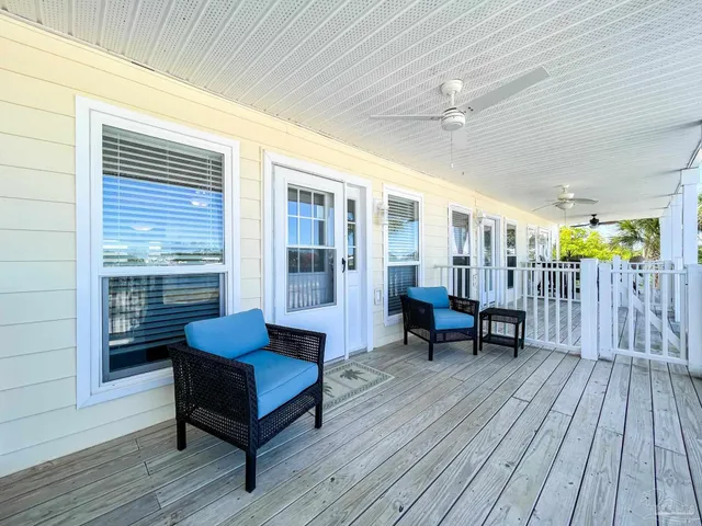 a balcony with furniture and wooden floor