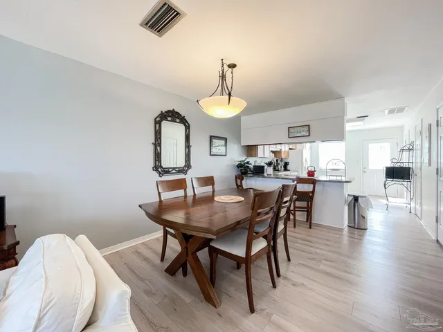 a view of a dining room with furniture and window