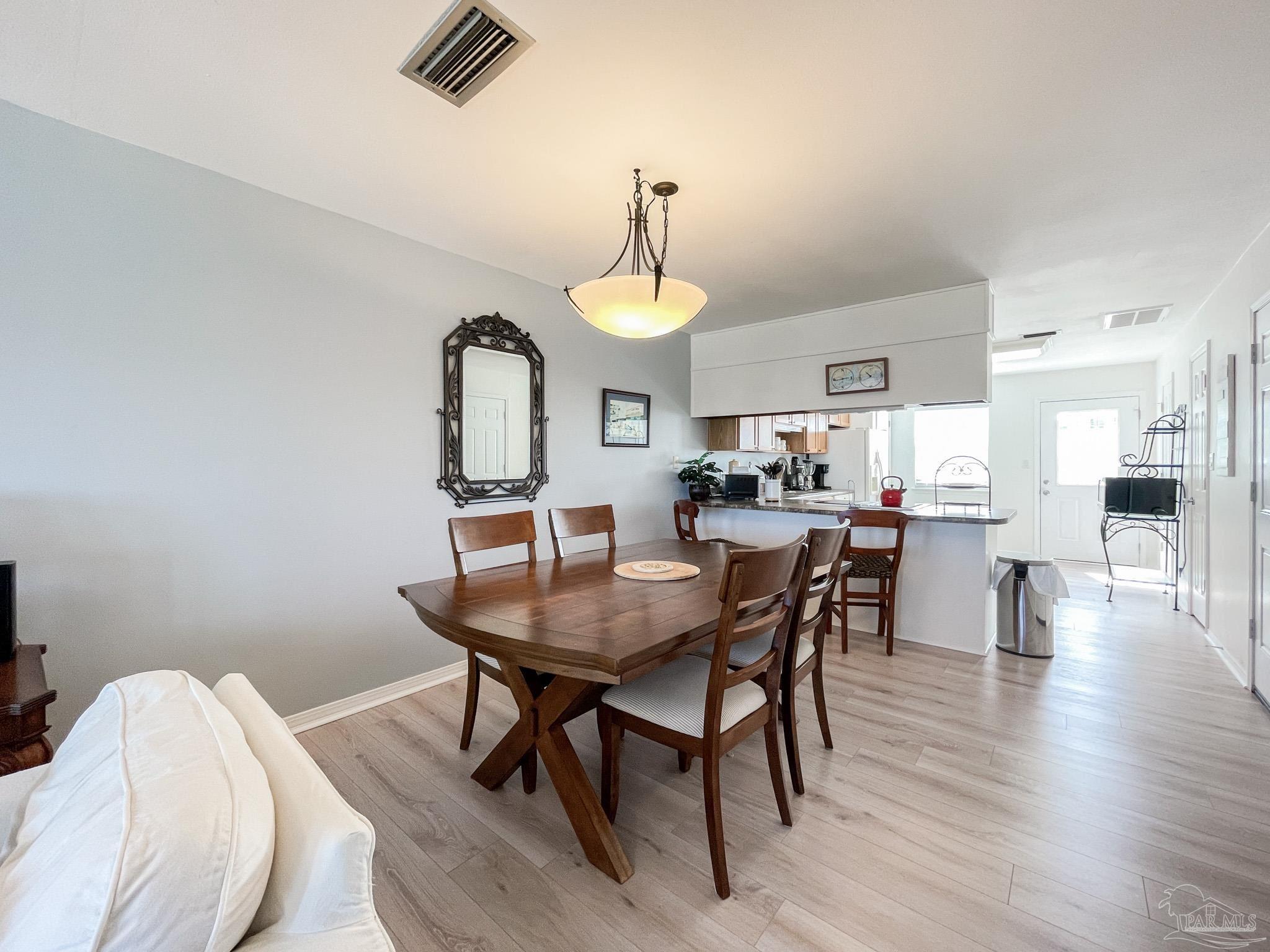 13948 River Road, Unit 3A Pensacola, FL 32507 - Photo 19 of 47 a view of a dining room with furniture and window
