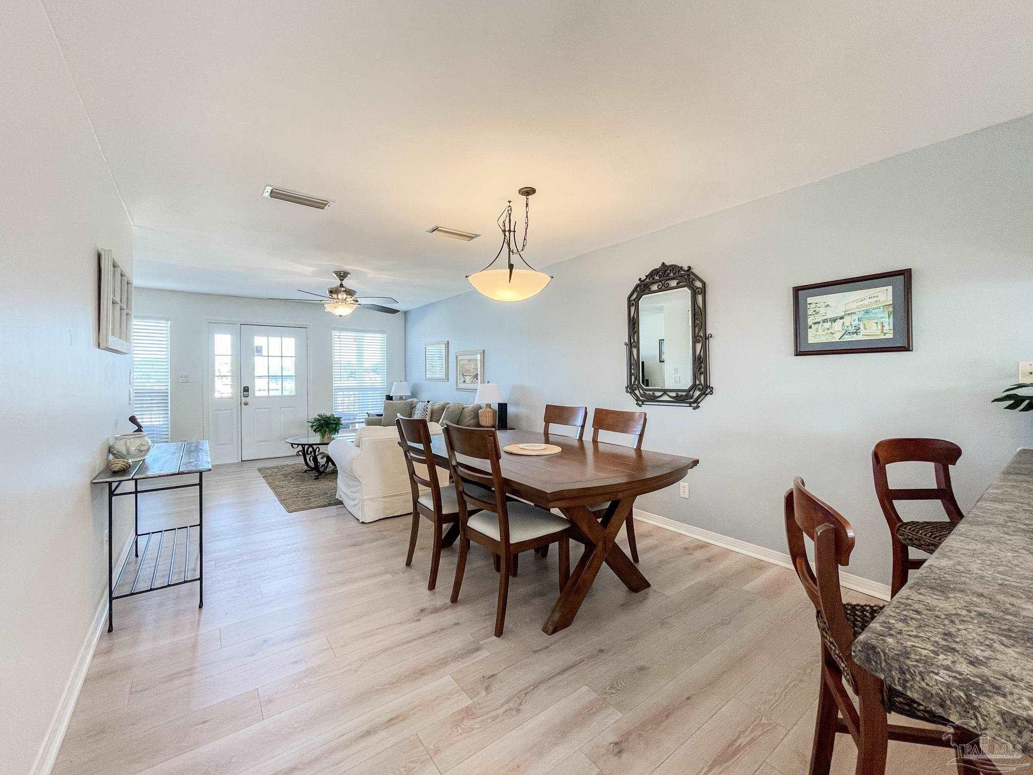 13948 River Road, Unit 3A Pensacola, FL 32507 - Photo 20 of 47 a view of a dining room with furniture and wooden floor