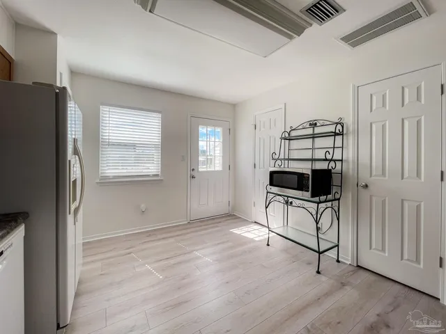 a view of kitchen and entryway with window