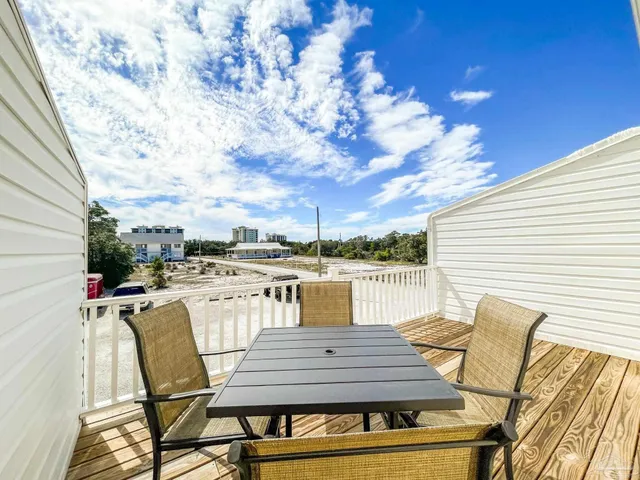 a view of a patio with table and chairs and potted plants