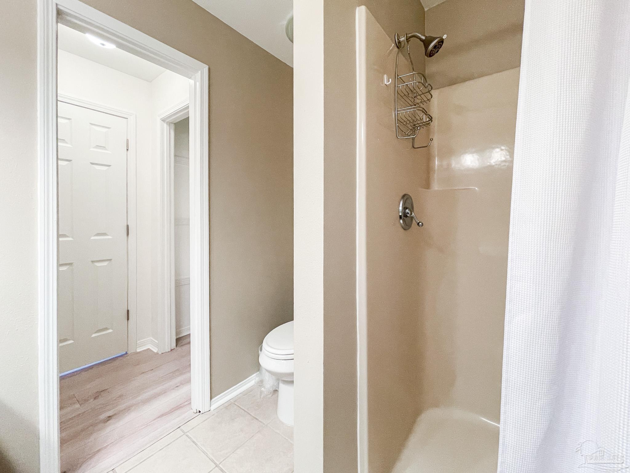 13948 River Road, Unit 3A Pensacola, FL 32507 - Photo 36 of 47 a bathroom with a granite countertop shower and a toilet