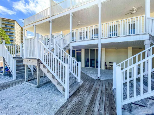 a view of a house with wooden deck