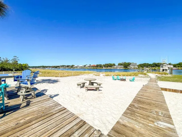 a view of swimming pool with outdoor seating and water view