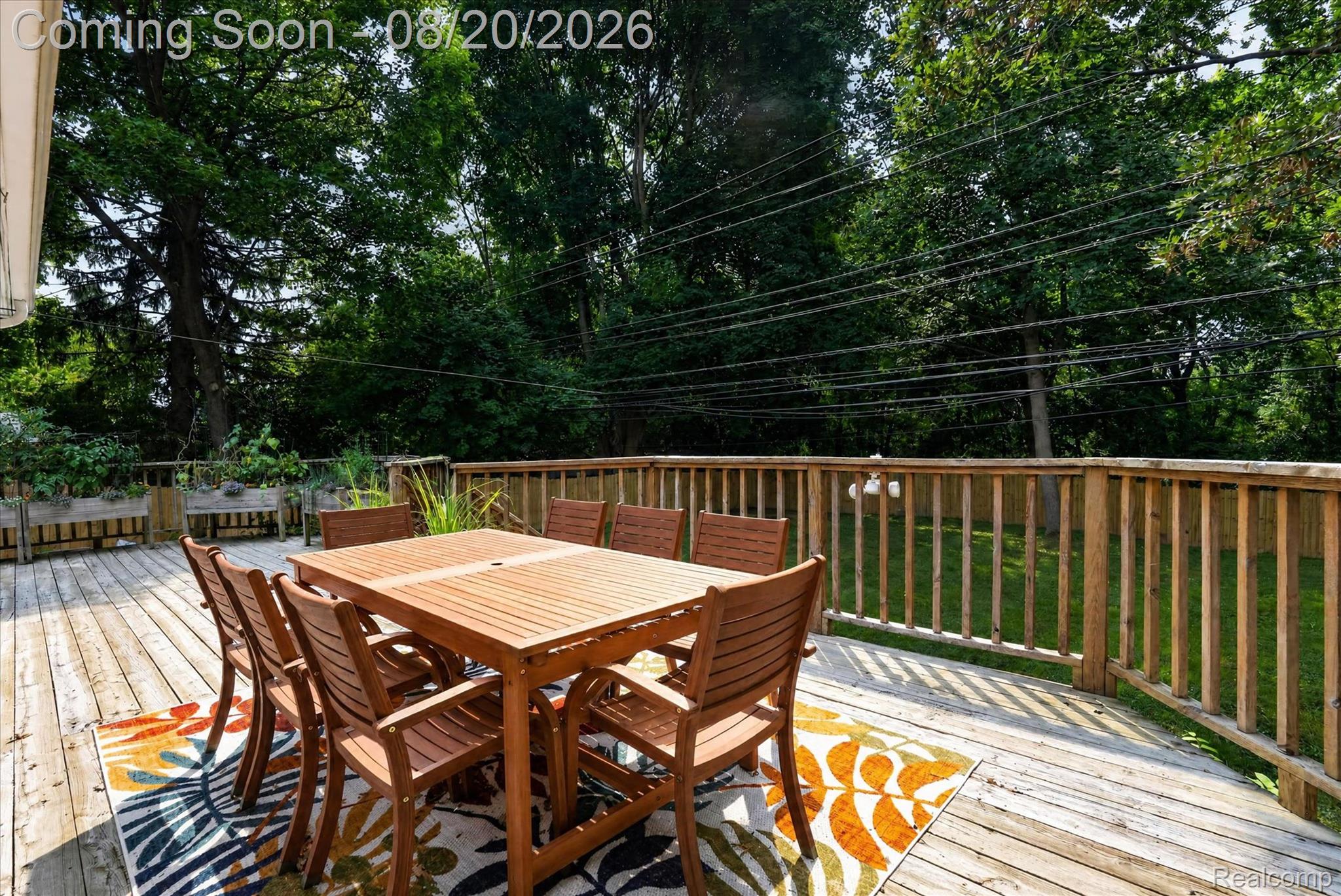 6235 Waldon Road Clarkston, MI 48346 - Photo 26 of 41 Spacious wood deck with a perimeter railing and integrated planter boxes, offering an expansive outdoor living area