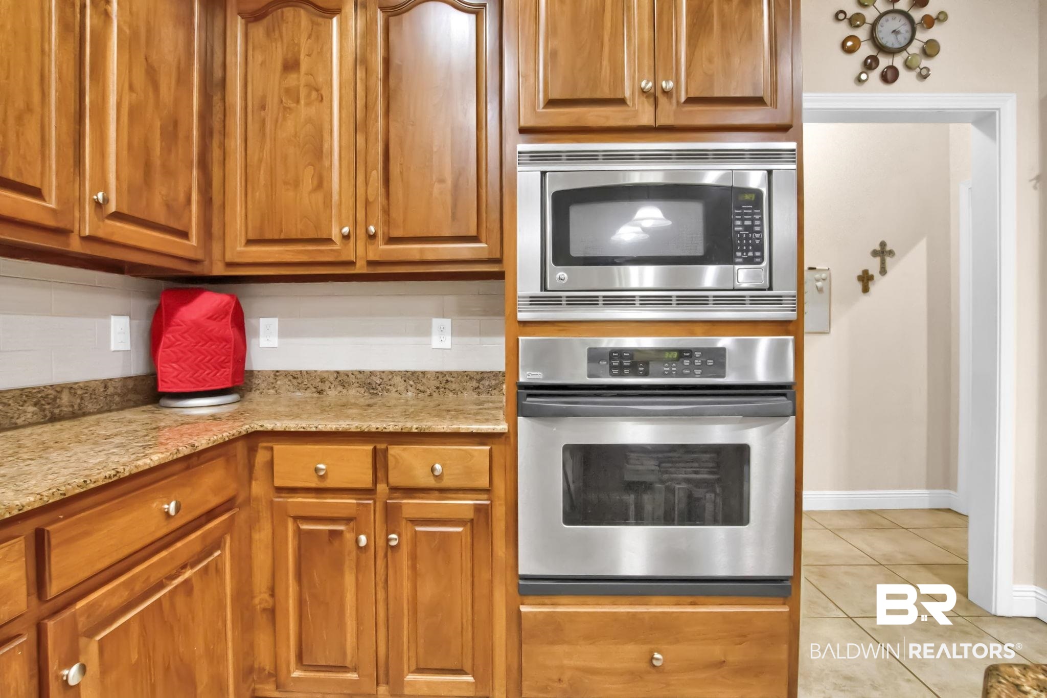 1 Bens Bluff Daphne, AL 36527 - Photo 22 of 56 Kitchen with light tile patterned flooring, light stone counters, stainless steel appliances, and backsplash