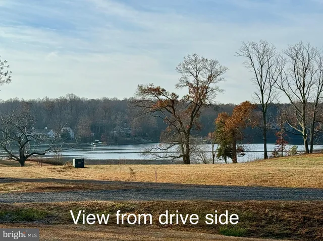 a view of a lake in between of two trees