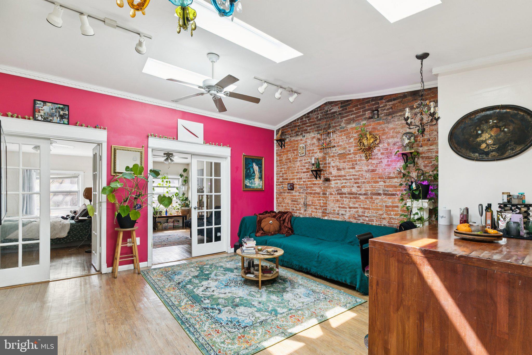 1333 Pine Street, Unit 4F Philadelphia, PA 19107 - Photo 1 of 20 a living room with furniture a rug and white walls
