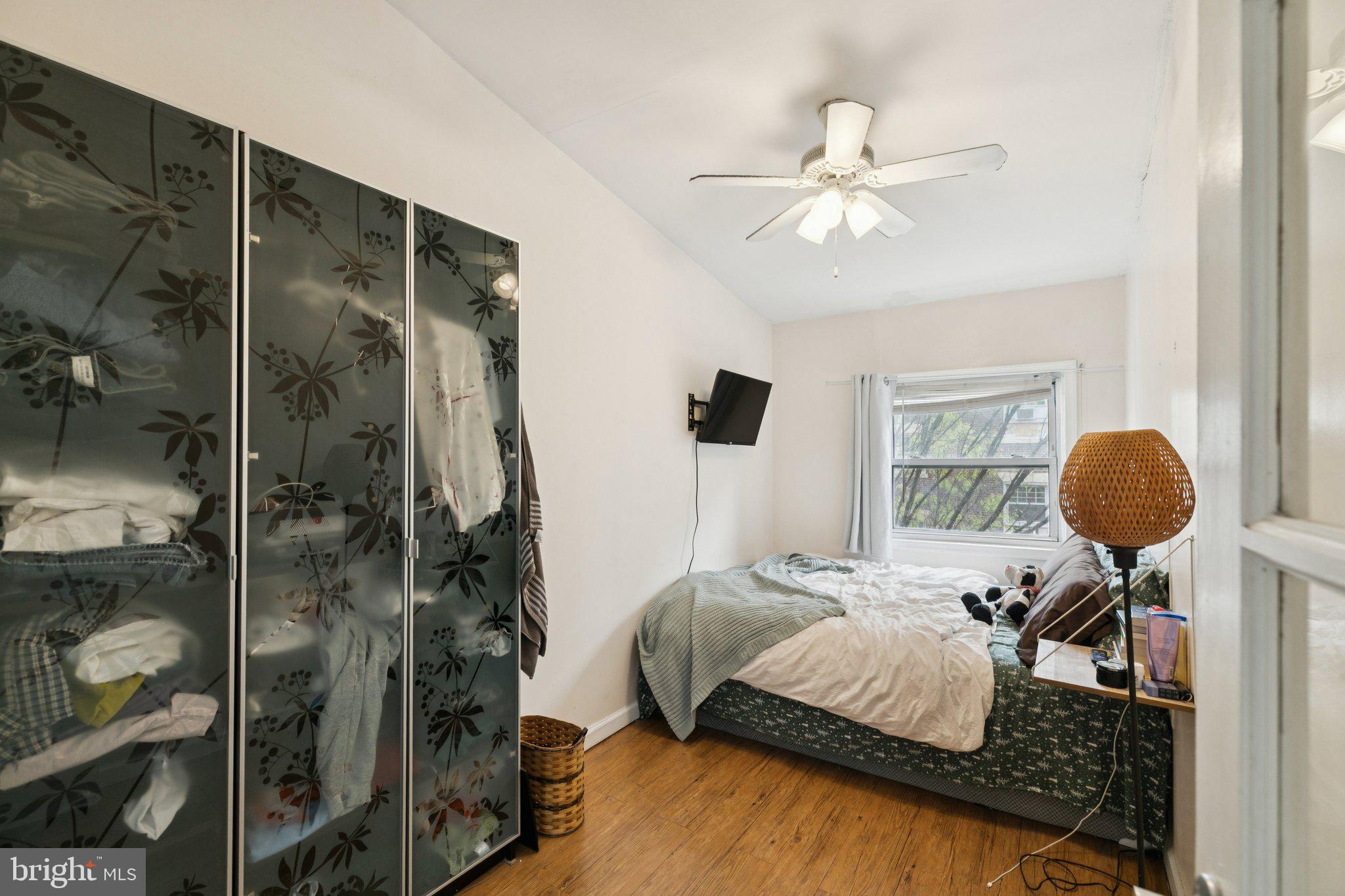 1333 Pine Street, Unit 4F Philadelphia, PA 19107 - Photo 16 of 20 a bedroom with a bed and a chandelier