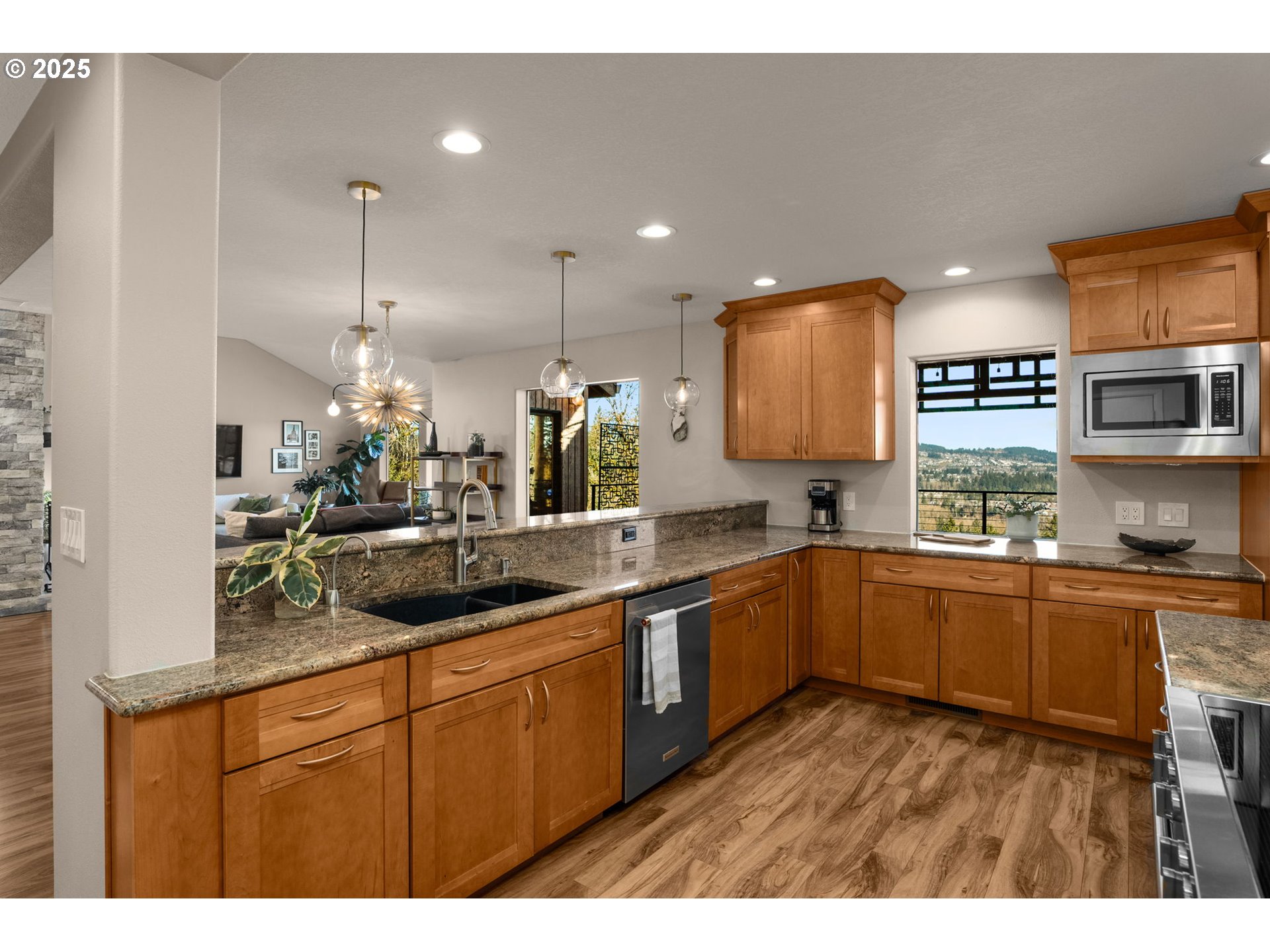 17287 South Overlook Road Oregon City, OR 97045 - Photo 14 of 48 a kitchen with stainless steel appliances granite countertop counter space a sink cabinets and wooden floor