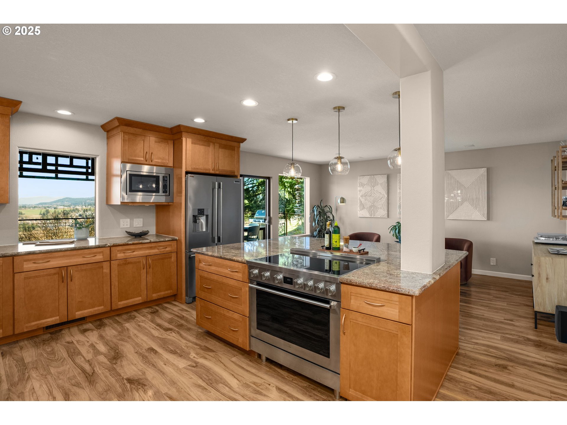 17287 South Overlook Road Oregon City, OR 97045 - Photo 15 of 48 a kitchen with stainless steel appliances kitchen island granite countertop a stove a sink dishwasher and a refrigerator