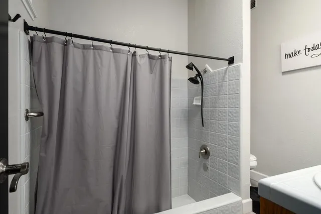 a bathroom with a shower and a sink