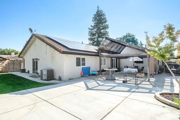 a building outdoor space with patio furniture and garden