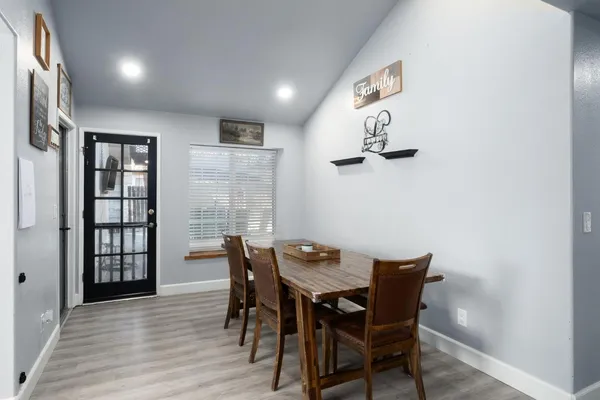 a view of a dining room with furniture and wooden floor
