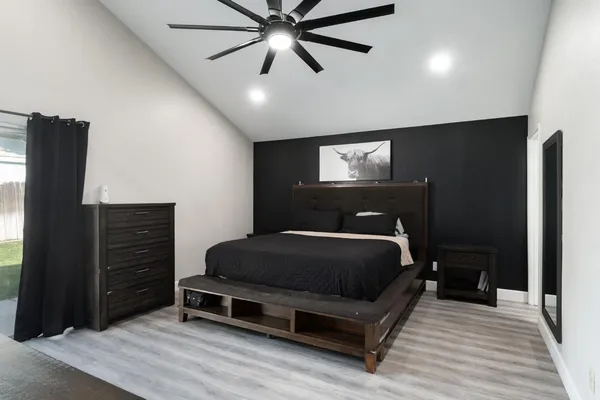 a bedroom with a bed and a ceiling fan