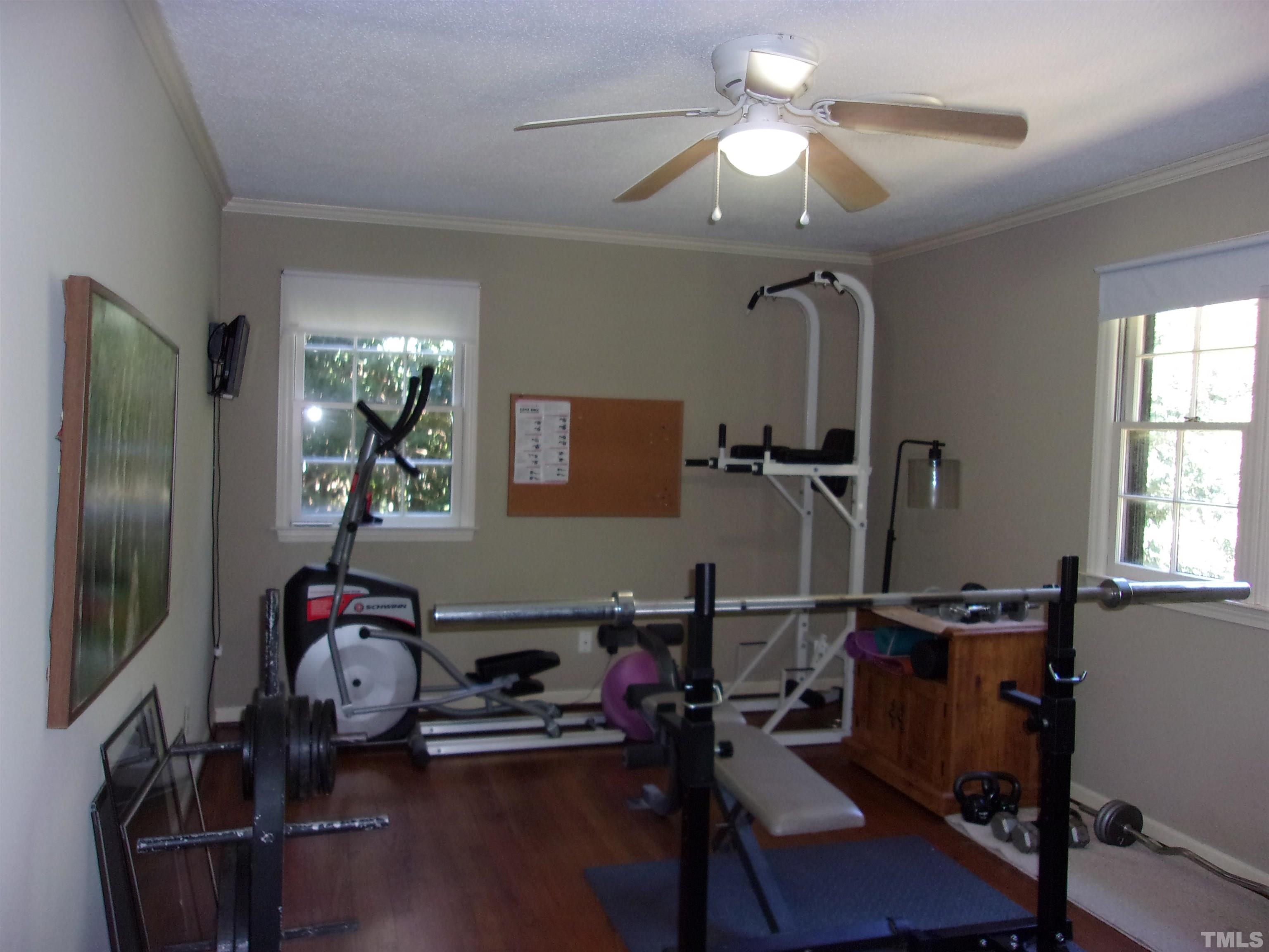 8709 Oneal Road Raleigh, NC 27613 - Photo 12 of 20 a room with gym equipment and a mirror