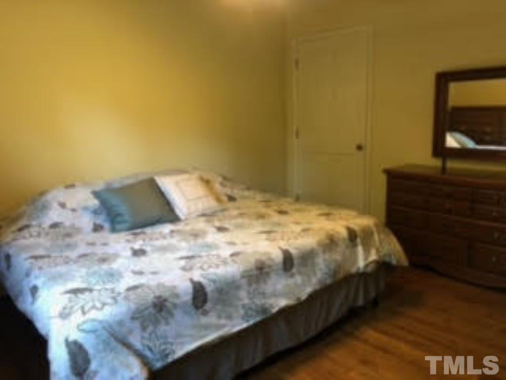 8709 Oneal Road Raleigh, NC 27613 - Photo 13 of 20 a bedroom with a bed and dresser