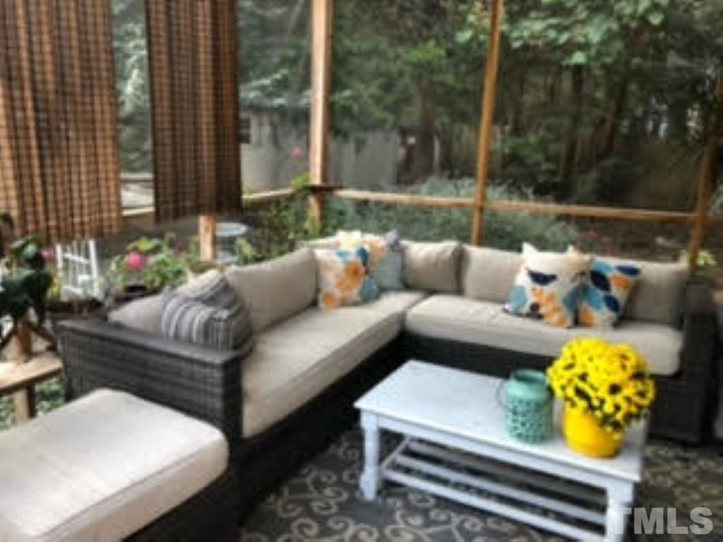 8709 Oneal Road Raleigh, NC 27613 - Photo 14 of 20 a view of a patio with couches and a table and chairs with garden view