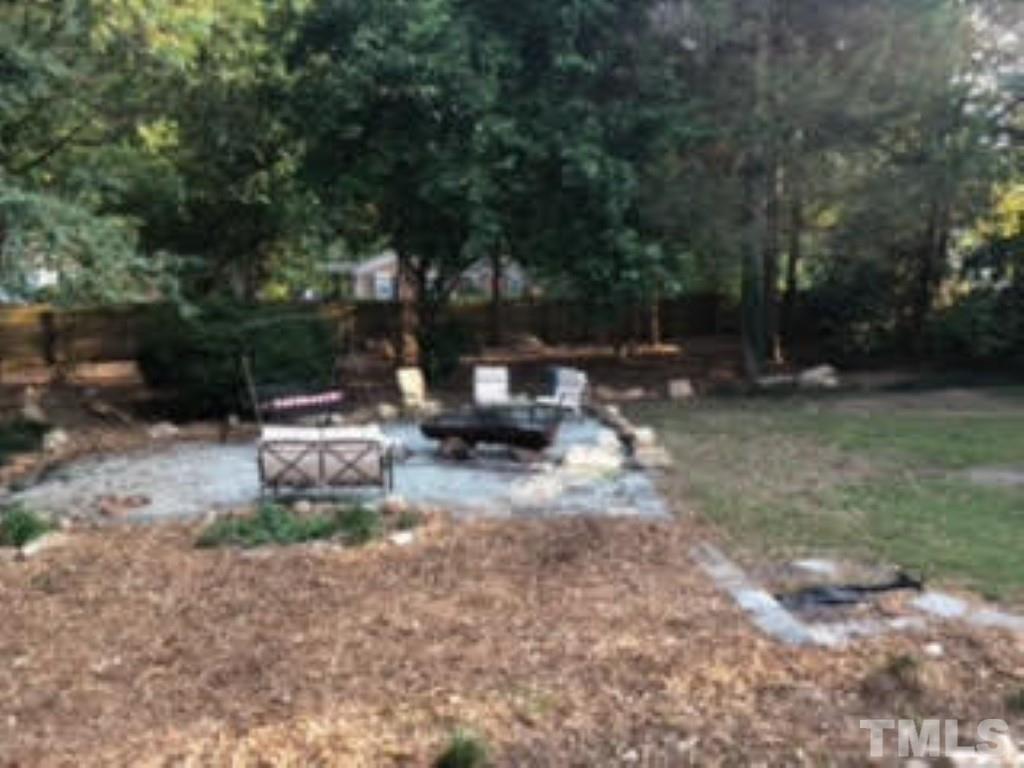8709 Oneal Road Raleigh, NC 27613 - Photo 16 of 20 a view of a backyard with sitting area