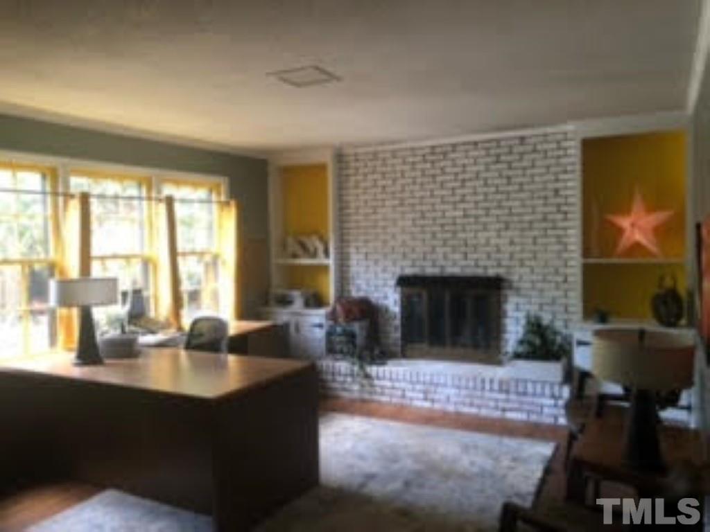 8709 Oneal Road Raleigh, NC 27613 - Photo 3 of 20 a living room with furniture and a fireplace