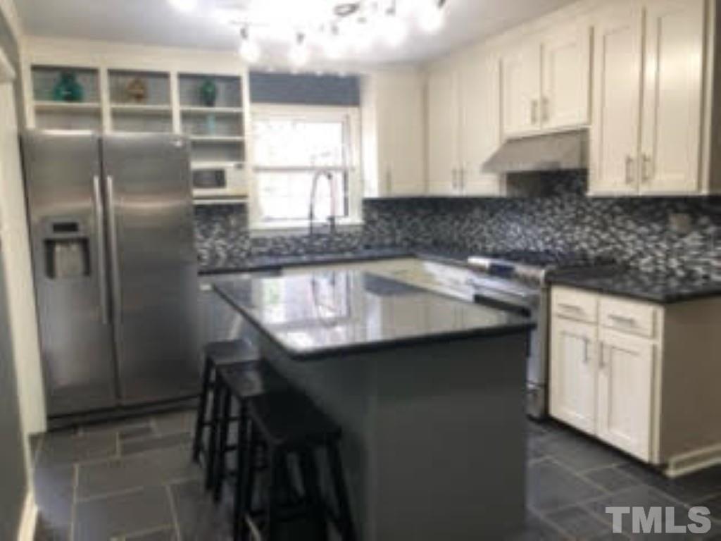 8709 Oneal Road Raleigh, NC 27613 - Photo 6 of 20 a kitchen with stainless steel appliances granite countertop a sink and a refrigerator