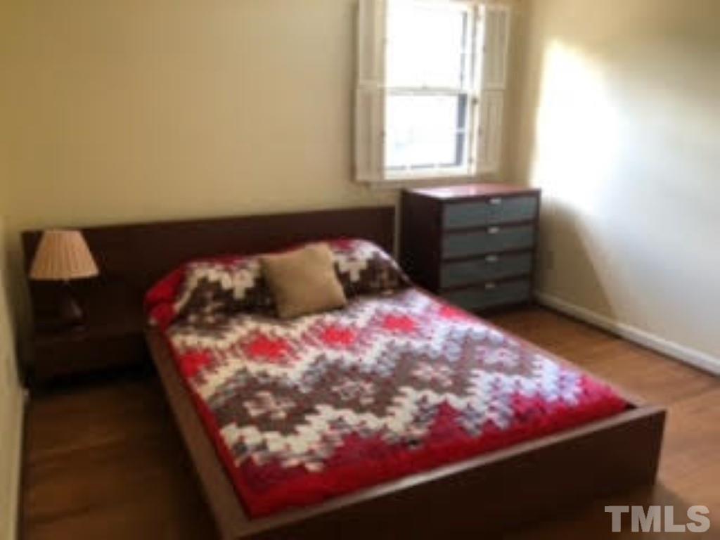 8709 Oneal Road Raleigh, NC 27613 - Photo 10 of 20 a bedroom with a bed and a window