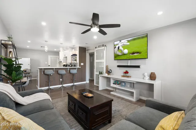 a living room with furniture and a flat screen tv