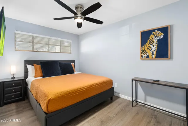 a bed sitting in a bedroom and painting on the wall