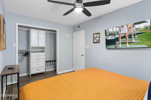 a bedroom with a bed and wooden floor