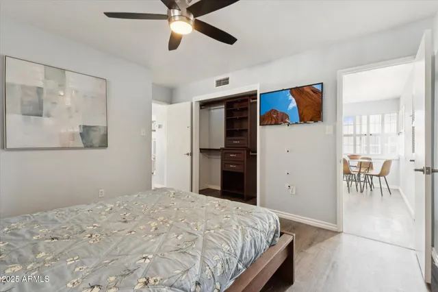 a bathroom with a granite countertop sink a toilet and mirror